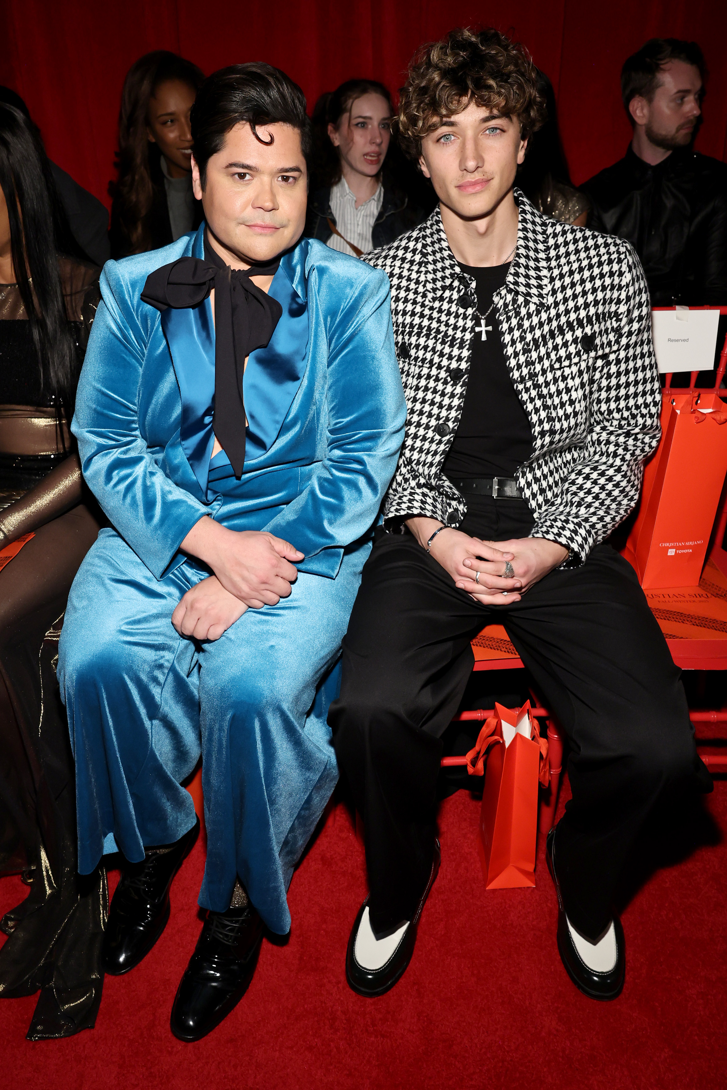 NEW YORK, NEW YORK - FEBRUARY 06: (L-R) Harvey Guillén and Gavin Casalegno attend the Christian Siriano Fall/Winter 2025 runway show at Chelsea Industrial on February 06, 2025 in New York City. (Photo by Jamie McCarthy/Getty Images for Christian Siriano)
