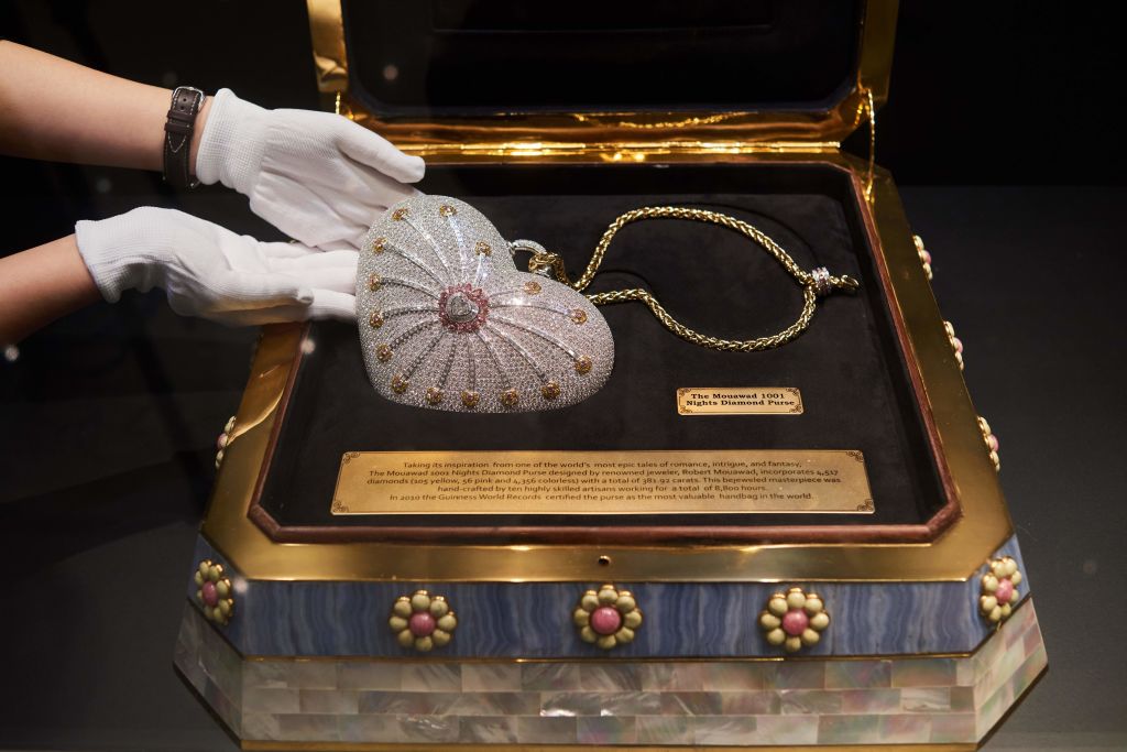 the most expensive purse in the world, most expensive handbag of all time, A heart-shaped handbag, 'The 'Mouawad 1001 Nights Diamond Purse', with 4517 incorporated diamonds with a total weight of 381.92 carats, is displayed with its presentation case during a Christie's auction preview in Hong Kong on October 17, 2017. 
The Robert Mouawad designed bag holds the world record for the most valuable handbag ever produced, with an original price of 3.8 million USD in 2010. / AFP PHOTO / Anthony WALLACE        (Photo credit should read ANTHONY WALLACE/AFP via Getty Images)