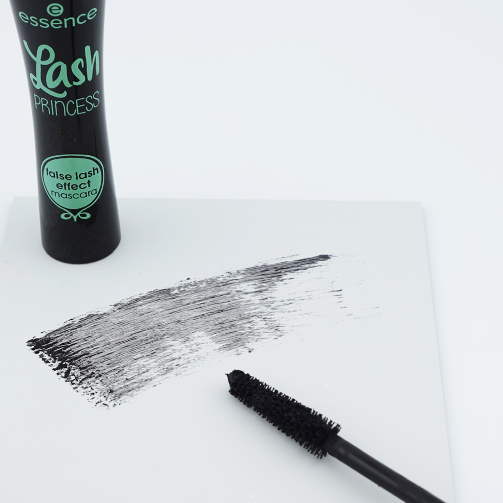 black and green mascara tube with product swatch