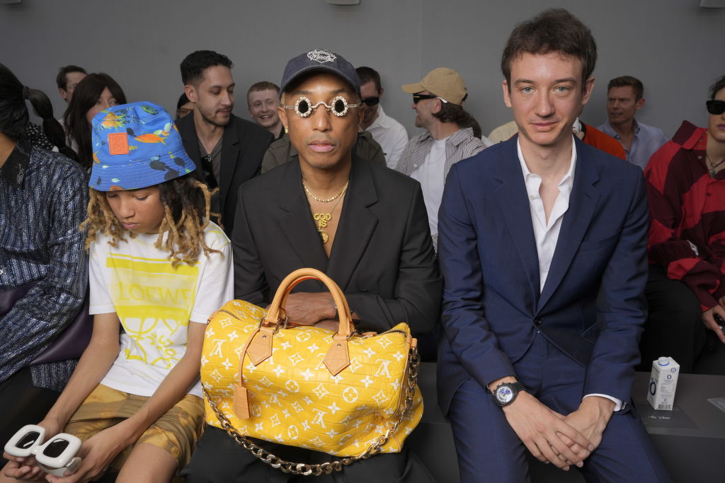 most expensive purses in the world, Rocket Williams, Pharrell Williams, and Frédéric Arnault at the Loewe Spring 2024 Menswear Collection Runway Show at the Gendarmerie Nationale-Garde Républicaine on June 24, 2023 in Paris, France. (Photo by Swan Gallet/WWD via Getty Images)
