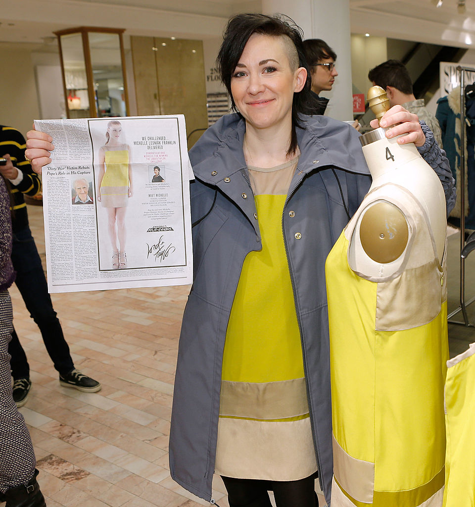 NEW YORK, NY - MARCH 22: Designer Michelle Franklin holds a newspaper insert as she poses with her Project Runway Lord & Taylor challenge during an in-store at the Lord & Taylor Flagship store on March 22, 2013 in New York City. (Photo by Jemal Countess/WireImage)