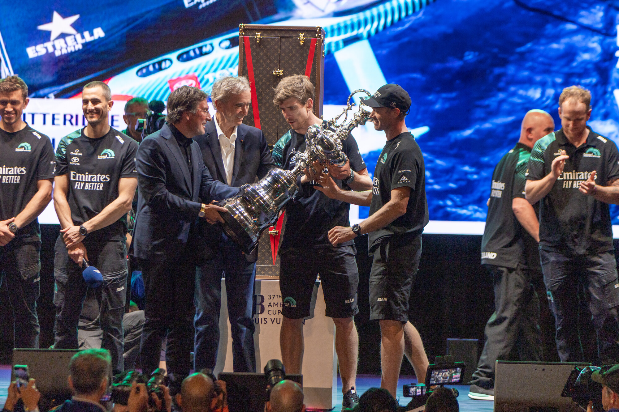 Pietro Beccari and Bernard Arnault present the Auld Mug to Emirates Team New Zealand, winners of the Louis Vuitton 37th America's Cup, at a ceremony in Barcelona.