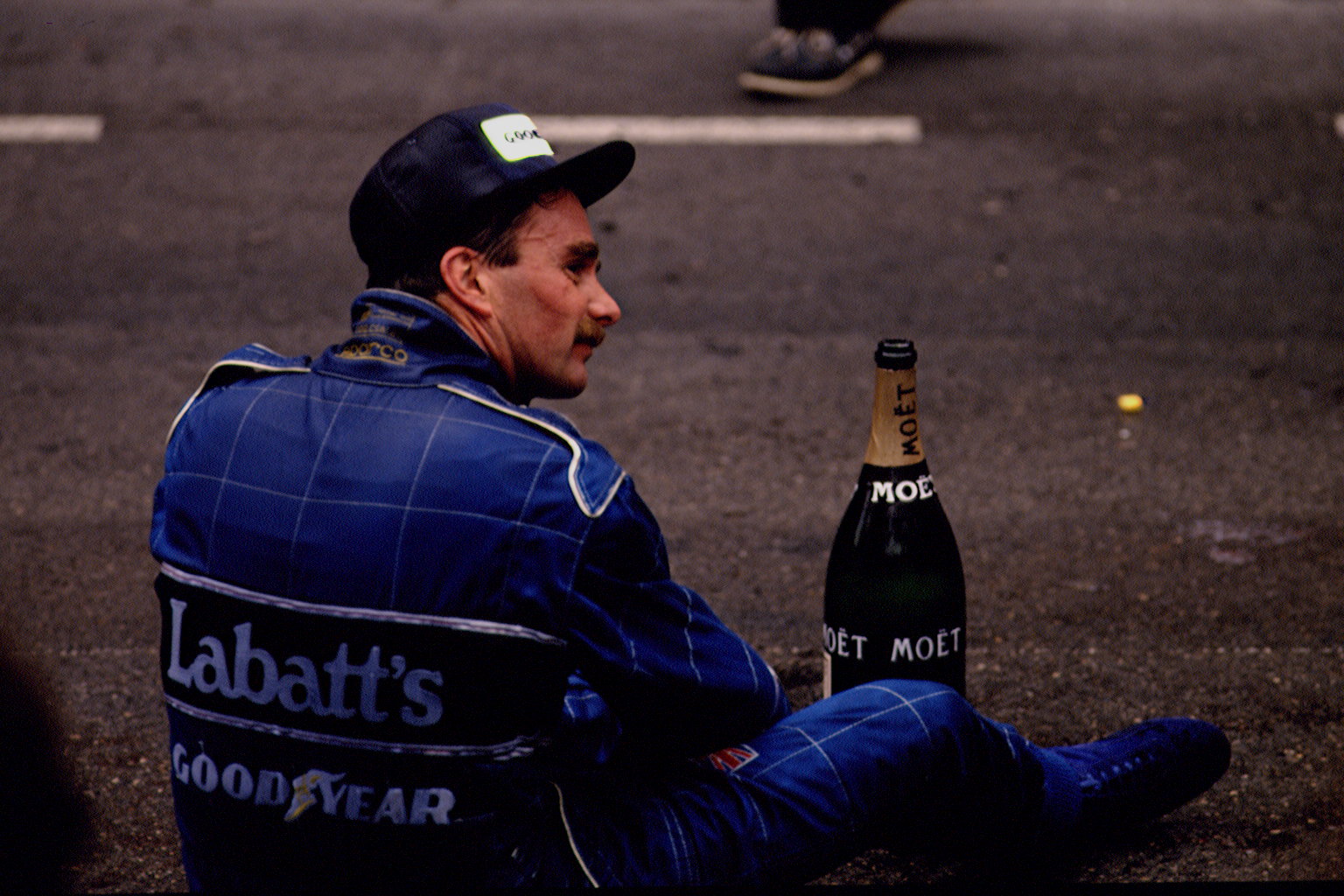 Nigel Mansell sitting with a bottle of champagne Moet et Chandon at Monaco Formula One Grand Prix. (Photo by Pascal Le Segretain/Sygma via Getty Images)