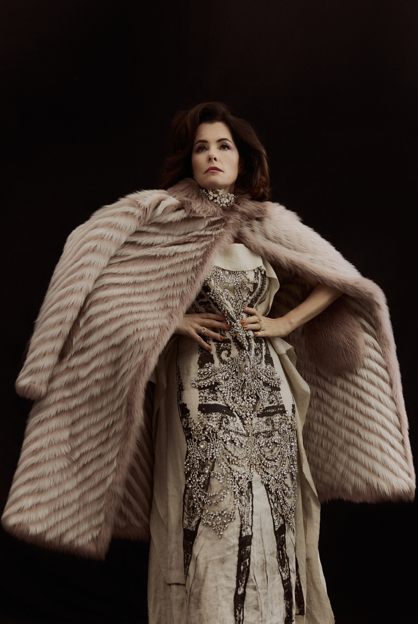 Gucci shearling coat and Erdem draped linen shift dress screen printed with cyanotype antique flapper dress and embellished with broken crystal pieces. Jennifer Behr Izabella Circlet in Swarovski crystal on a plated brass base with ribbon ties.( worn as necklace) Yvonne Lèon Diamond Feline earring. Grace Lee link column ring with diamonds. Bea Bongiasca Baby Vine Ring with diamond pavè in drop shape. Boochier jumbo 18K recycled yellow gold diamond Slinkee ring.