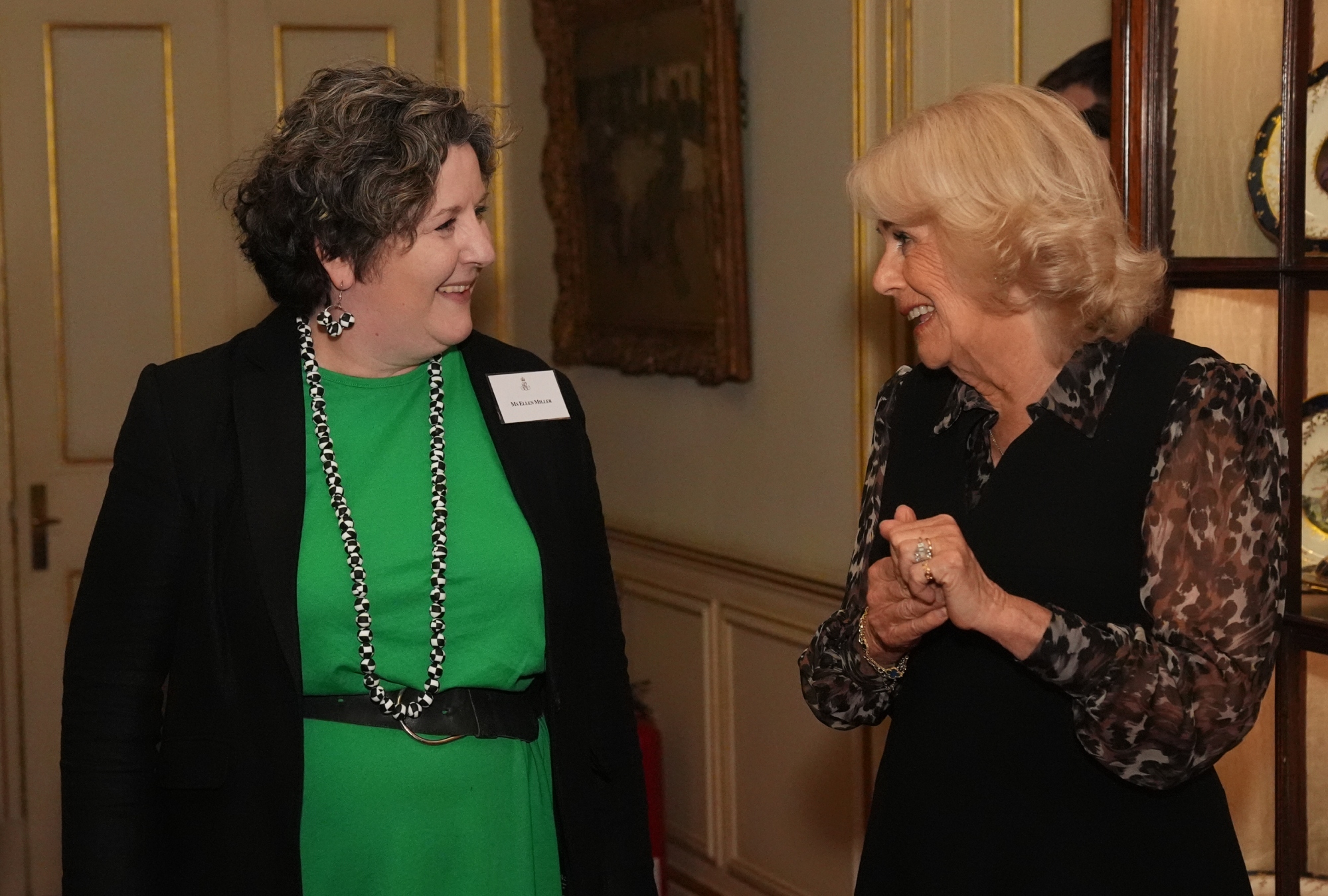 Queen Camilla wears a dress by Fiona Clare at a reception for the anniversary of SafeLives in London.