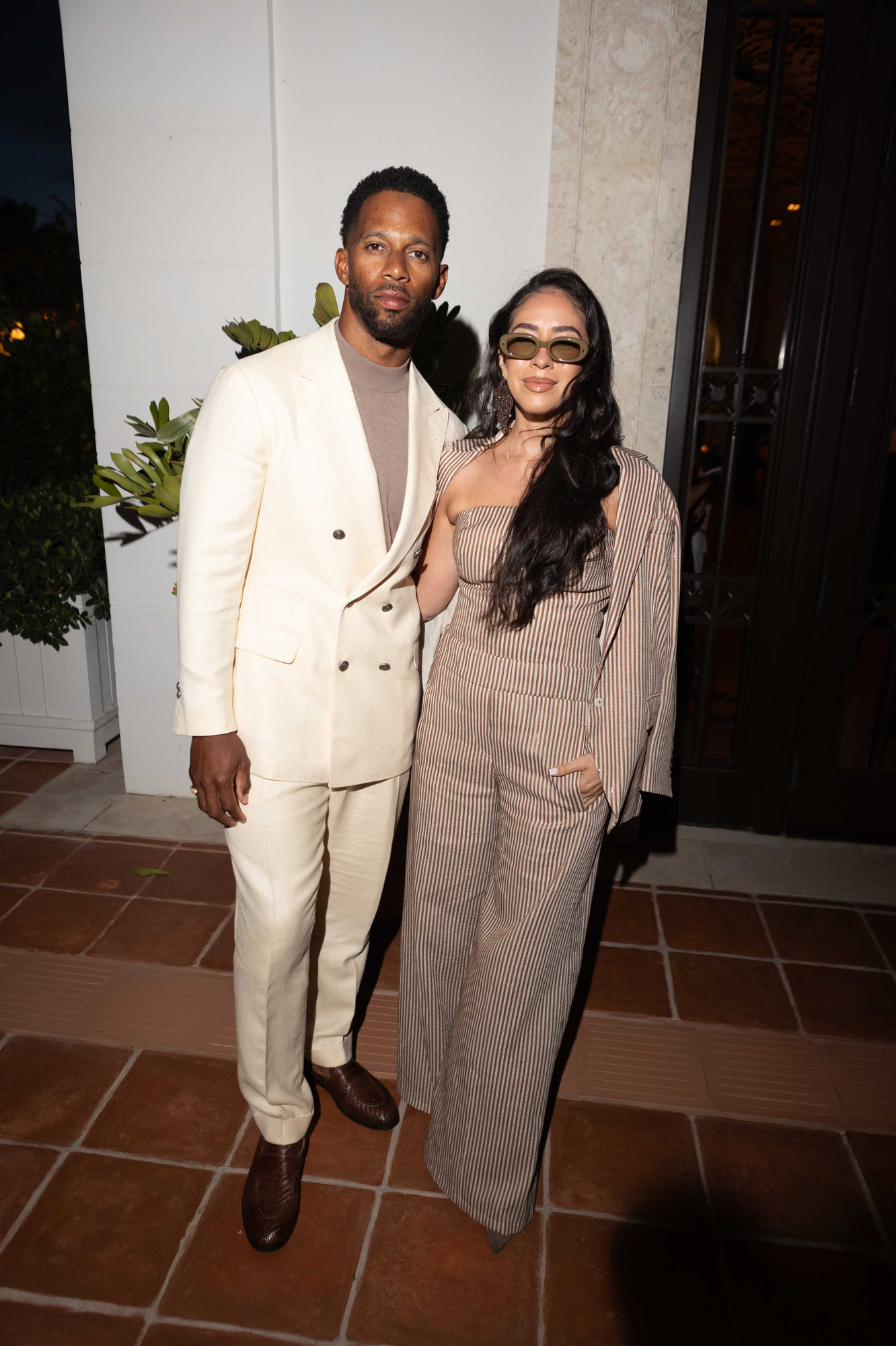 Victor Cruz and Orange Calderón attend the Brunello Cucinelli dinner at Lido Surf Club.