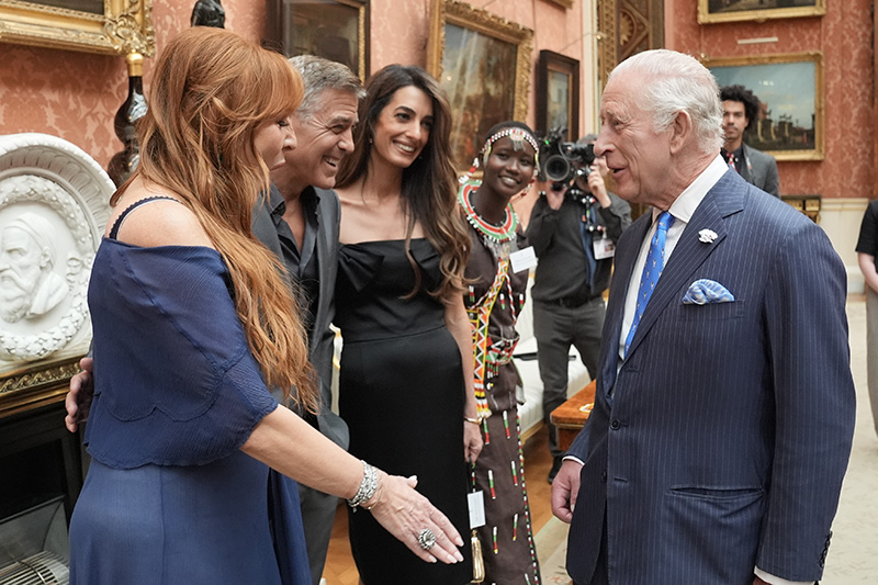 LONDON, ENGLAND - JUNE 25: King Charles III speaks with (left to right) Charlotte Tilbury, George Clooney, Amal Clooney and Alice Ngitira during a reception for the winners of the King's Trust Awards 2025 at Buckingham Palace on June 25, 2025 in London, England. (Photo by Stefan Rousseau-WPA Pool/Getty Images)