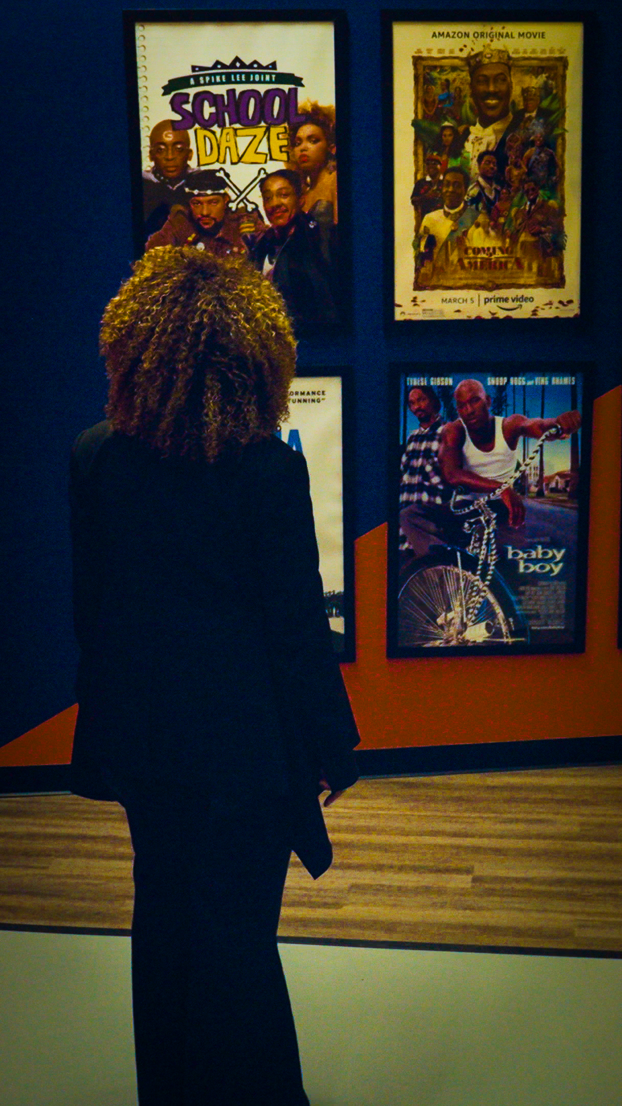 Ruth E. Carter looking at posters for projects she's worked on.