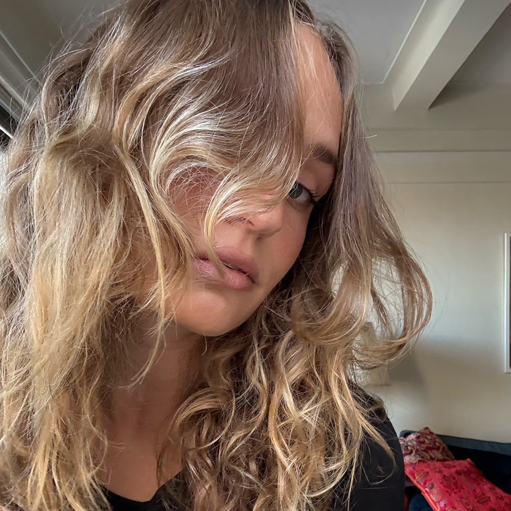 author taking photo of her hair after using dae products