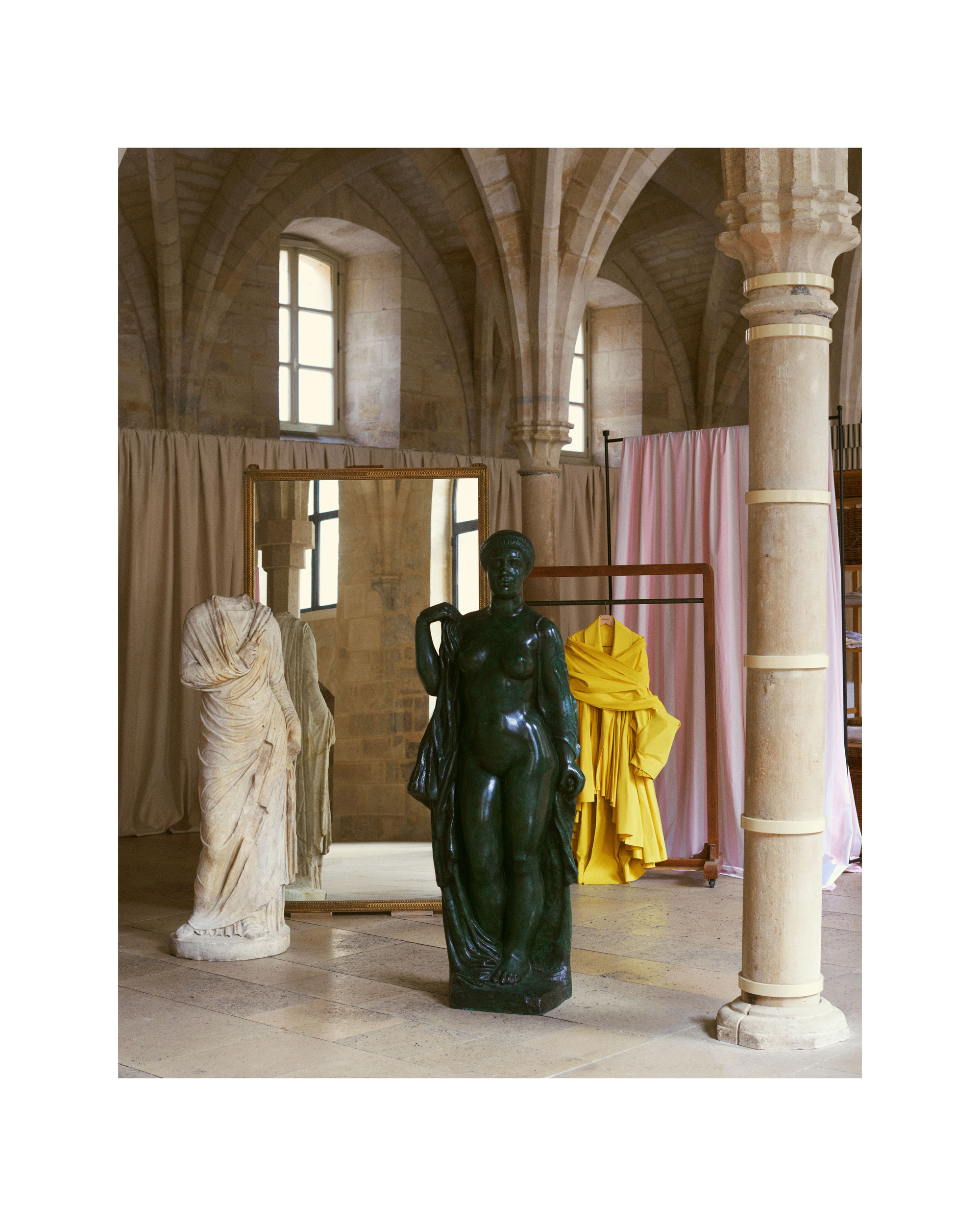 Roman draped feminine figure, second century of the common era, courtesy of Galerie Chenel; Aristide Maillol, Baigneuse à la draperie or Baigneuse drapée or La Seine (1er état), 1921, courtesy of Galerie Dina Vierny; and Jacquemus' Le Trench Provençale from spring 2026.
