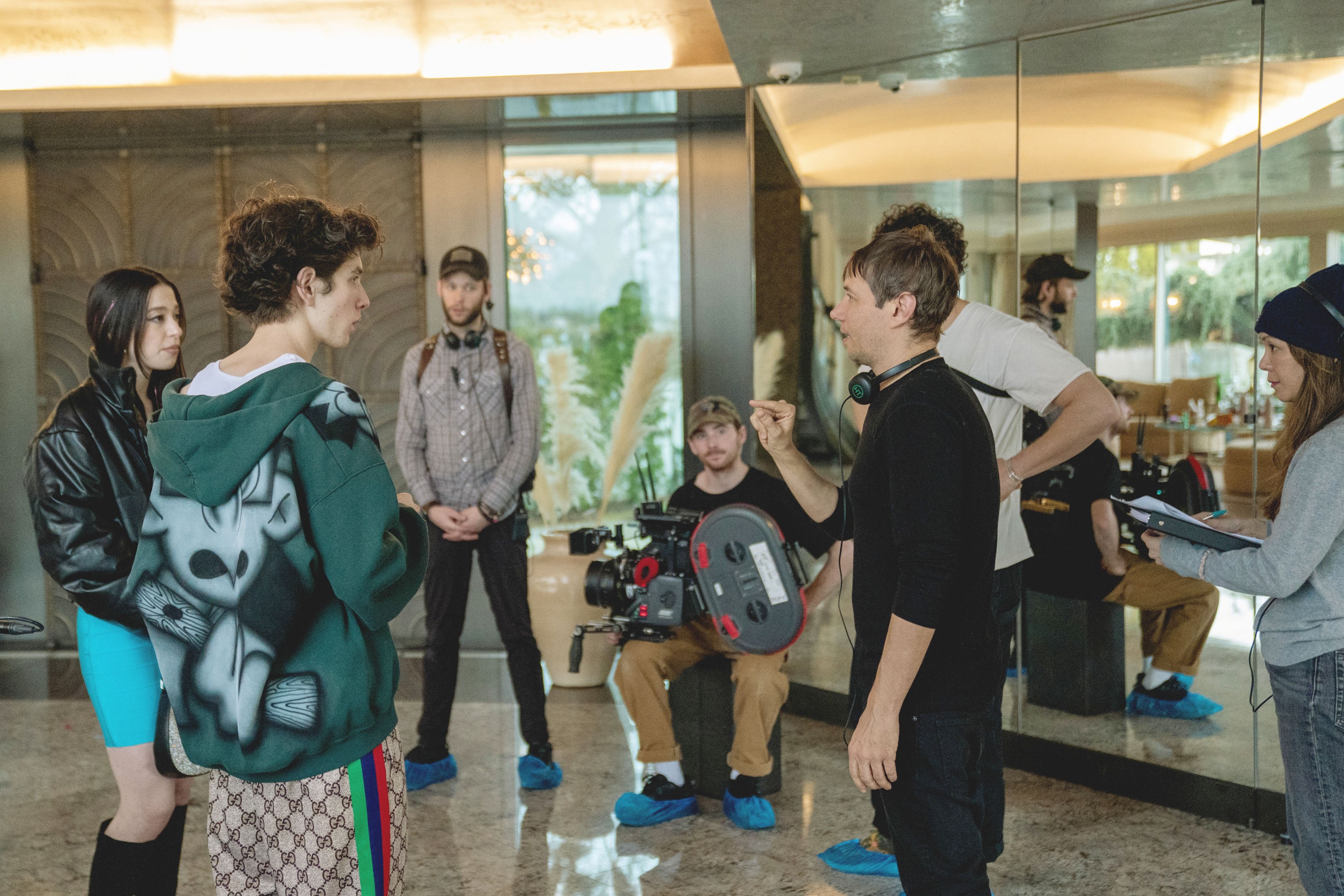 ANORA, foreground from left: Mikey Madison, Mark Eidelshtein, director Sean Baker, on set, 2024. ph: Augusta Quirk /© Neon /Courtesy Everett Collection