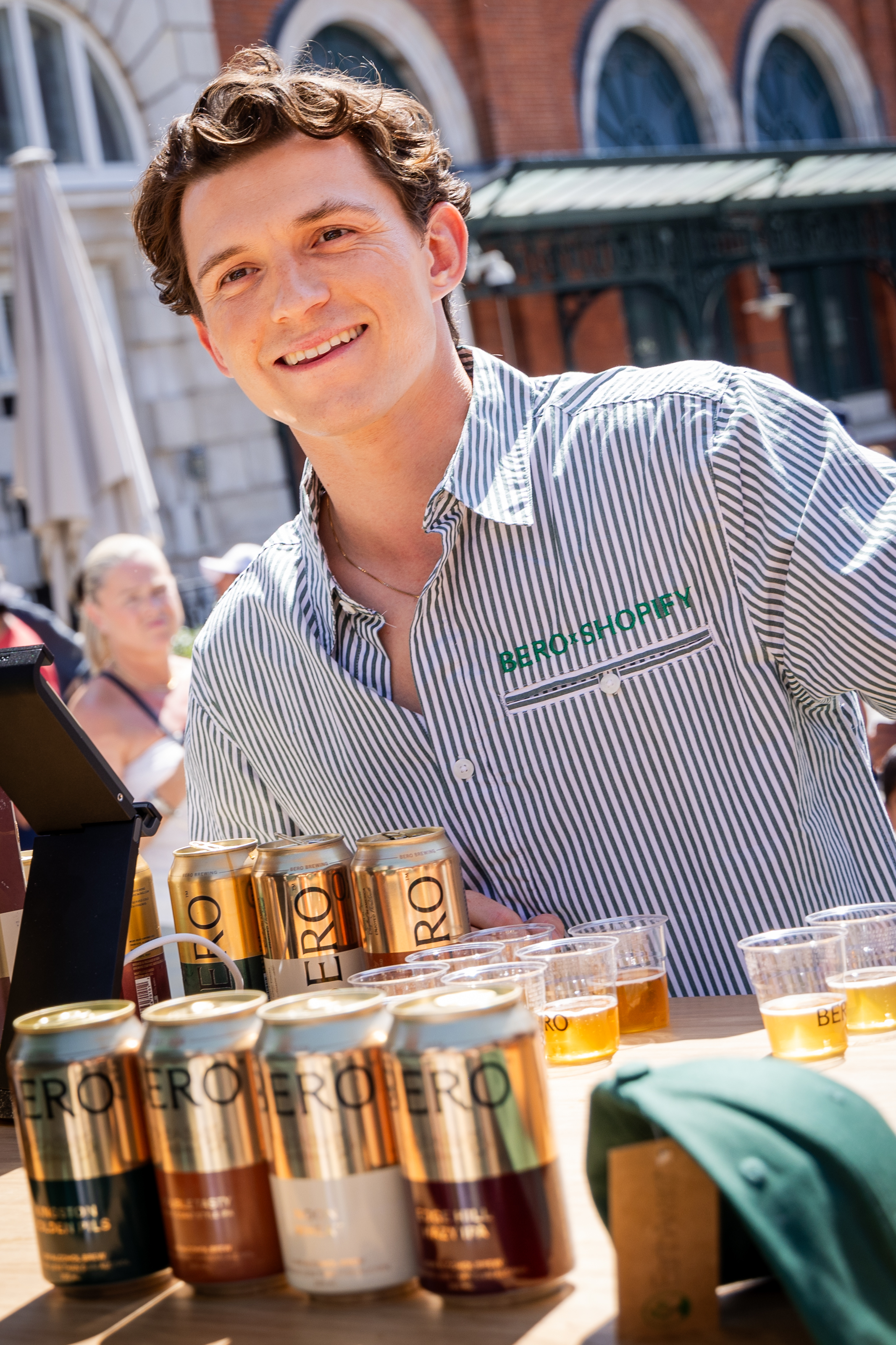 LONDON, ENGLAND - JULY 12: Tom Holland meets fans and serves BERO beer at the BERO x Shopify pop up event at Covent Garden on July 12, 2025 in London, England. (Photo by Tristan Fewings/Getty Images)