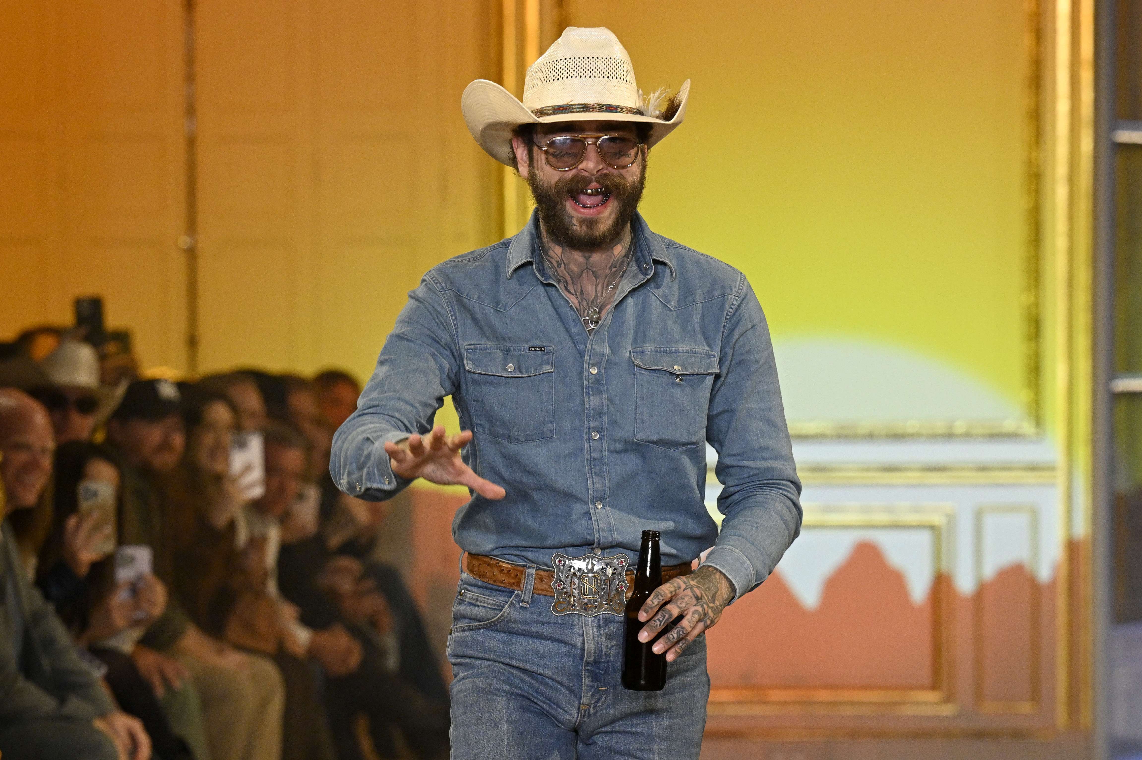 PARIS, FRANCE - SEPTEMBER 01: Post Malone acknowledges the audience during the Austin Post Runway Show on September 01, 2025 in Paris, France. (Photo by Kristy Sparow/Getty Images)