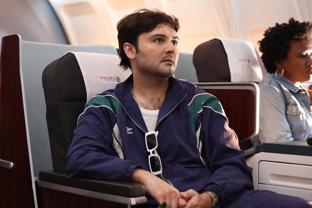 SATURDAY NIGHT LIVE -- Episode 1884 -- Pictured: John Higgins during the PDD: First Class sketch on Saturday, May 17, 2025 -- (Photo by: Holland Rainwater/NBC)