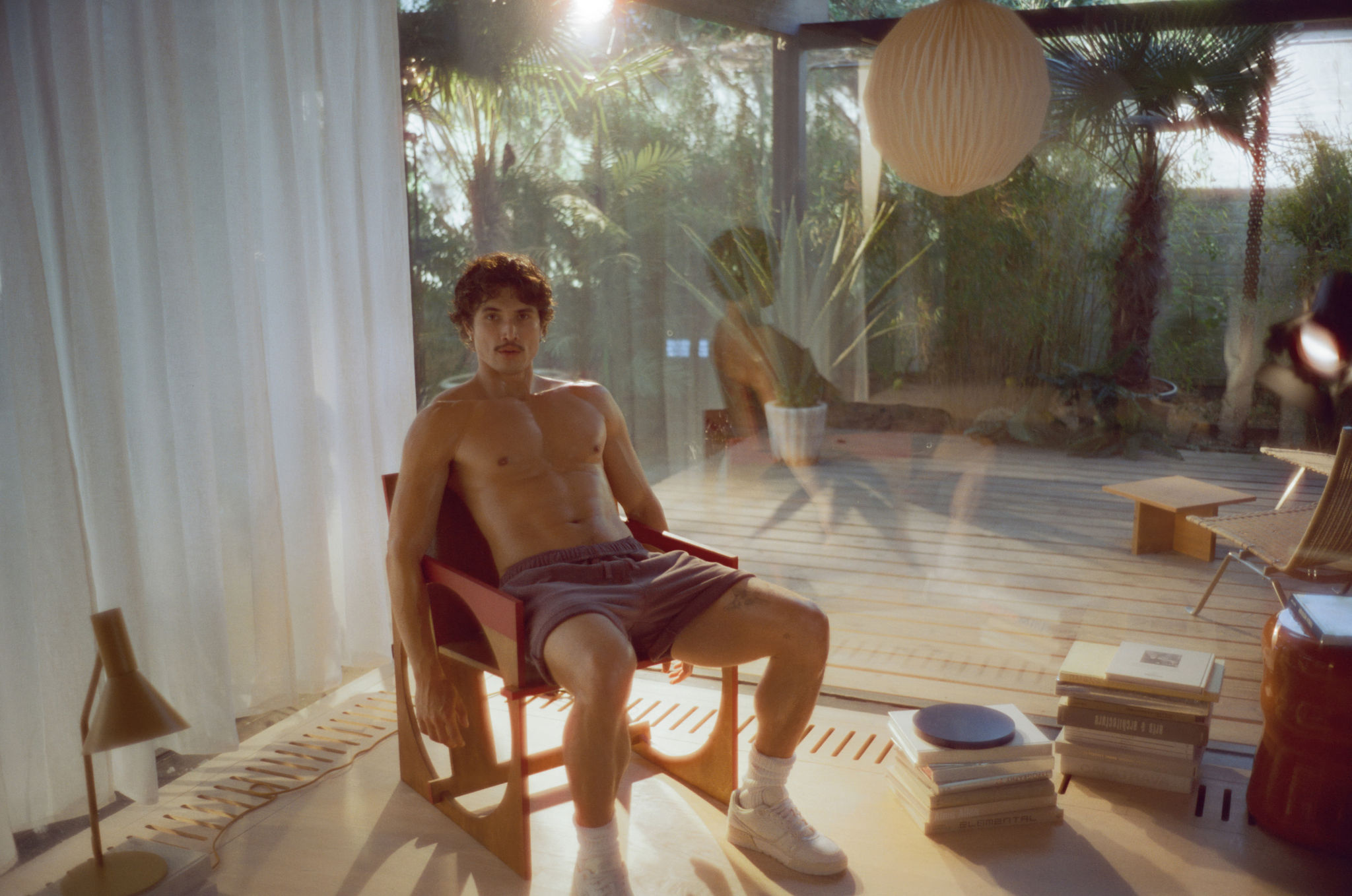 Charles Melton modeling Soho Sneaker for Coach
