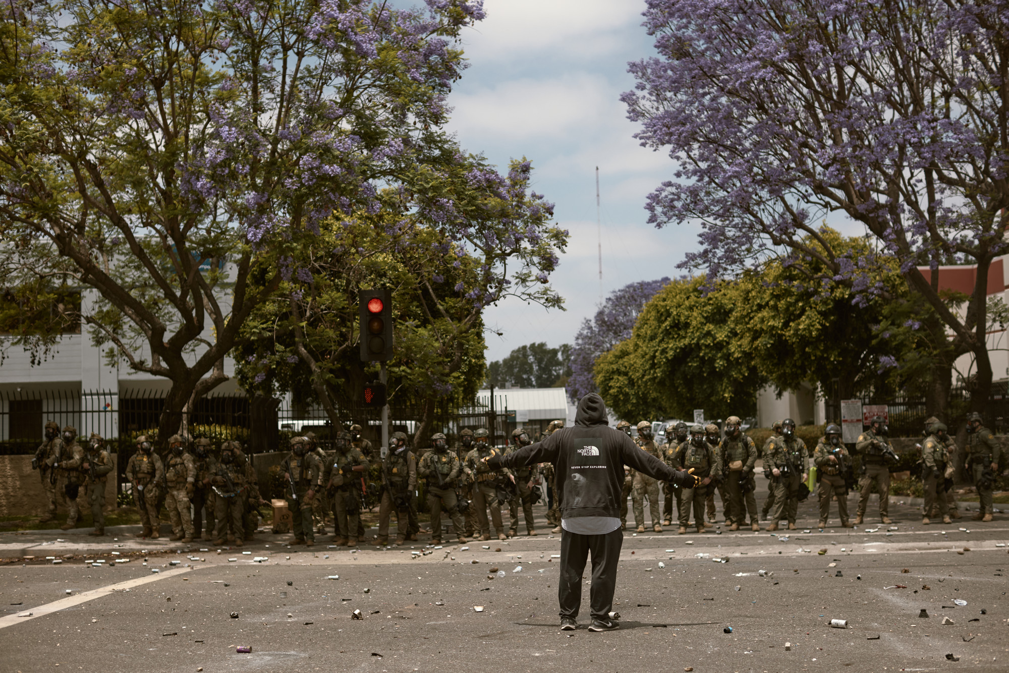 LOS ANGELES, CALIFORNIA - JUNE 7: Protests and confrontations between immigration rights supporters and law enforcement take place in Paramount and downtown Los Angeles, California, following recent raids by Immigration and Customs Enforcement (ICE) and Department of Homeland Security (DHS) agents on June 7, 2025. Demonstrators are seen using blockades and facing tear gas, flashbang grenades, and pepper ball shots, while rising tensions lead to damaged property across the affected areas. (Photo by Taurat Hossain/Anadolu via Getty Images)