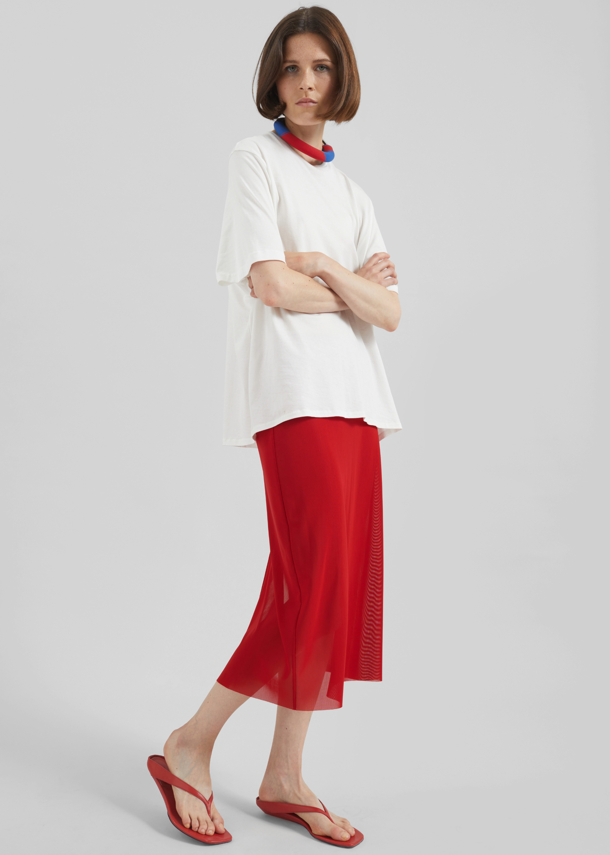 model wearing a red sheer skirt look from The Frankie Shop.