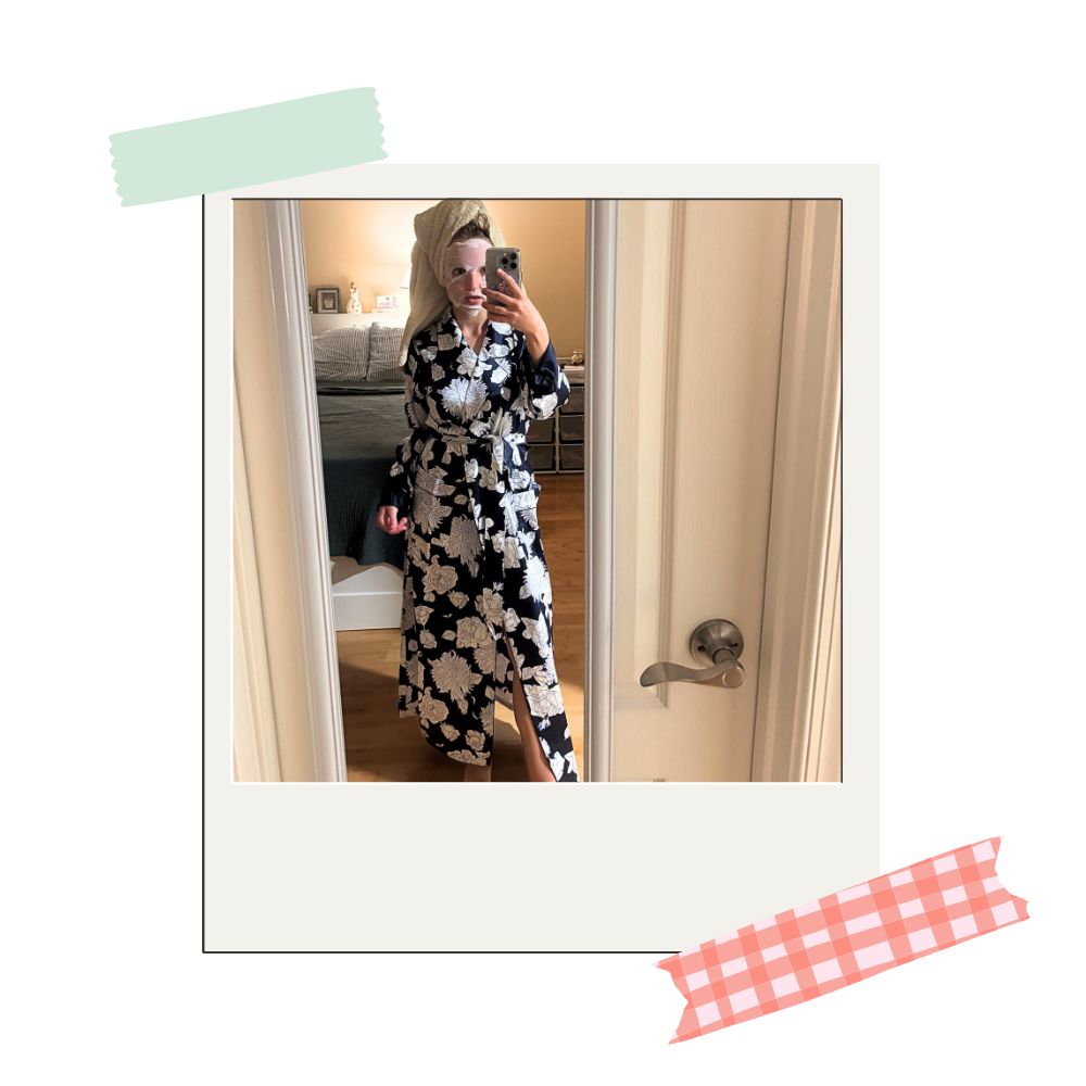 writer testing out petite plume's midnight blooms robe while wearing a face mask